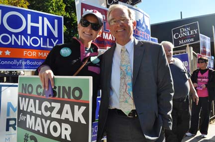 Preliminary election: Bill Walczak, with his daughter Elizabeth, highlighted his opposition to a casino in Boston on his election day signage. The two are shown outside the Cristo Rey School where the candidate voted this morning. Photo by Bill Forry